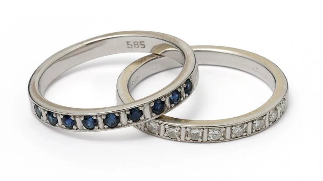 Two eternity rings set with diamonds and sapphires, mounted in 14k