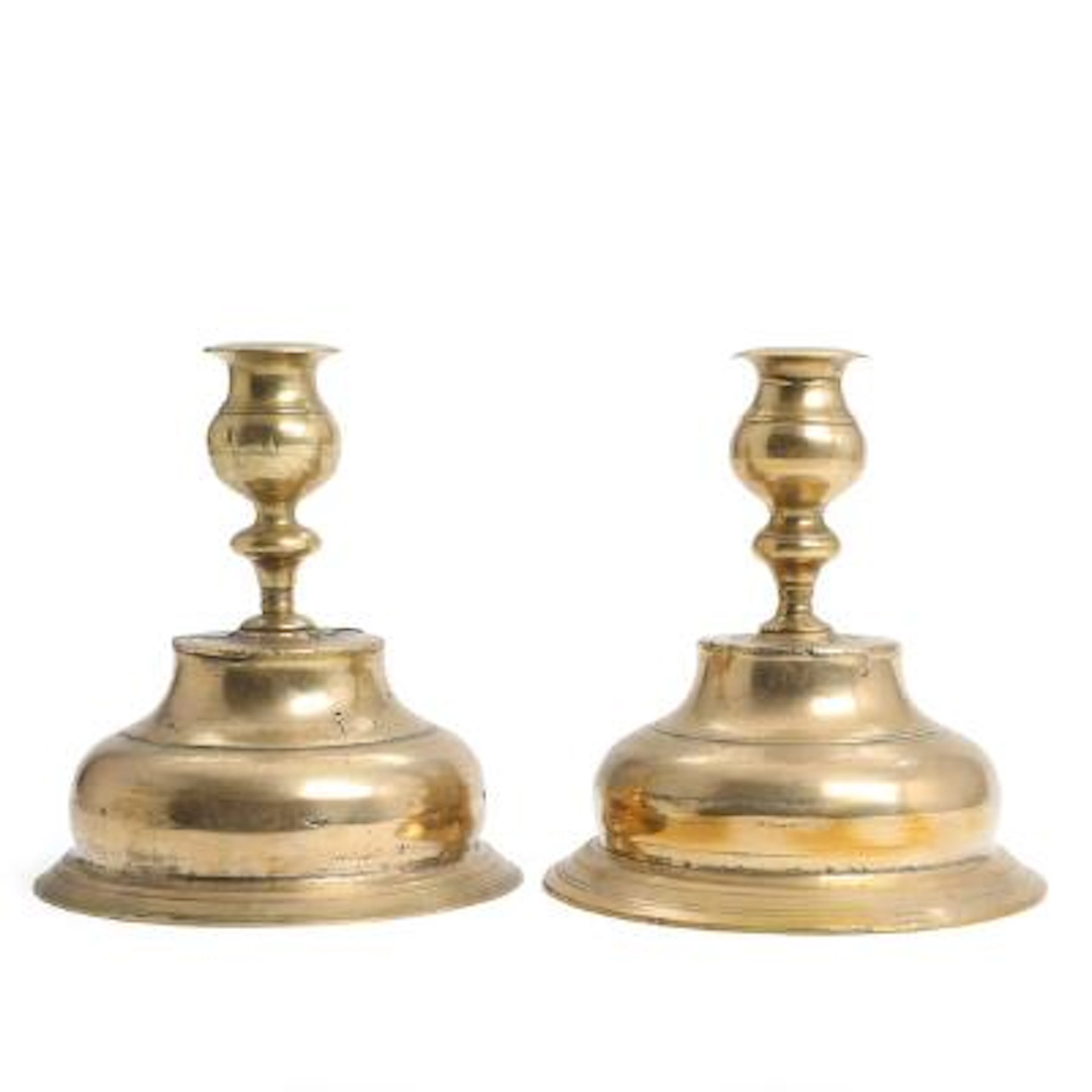 A pair of Baroque brass candlesticks on domed bases. Early 18th century.
