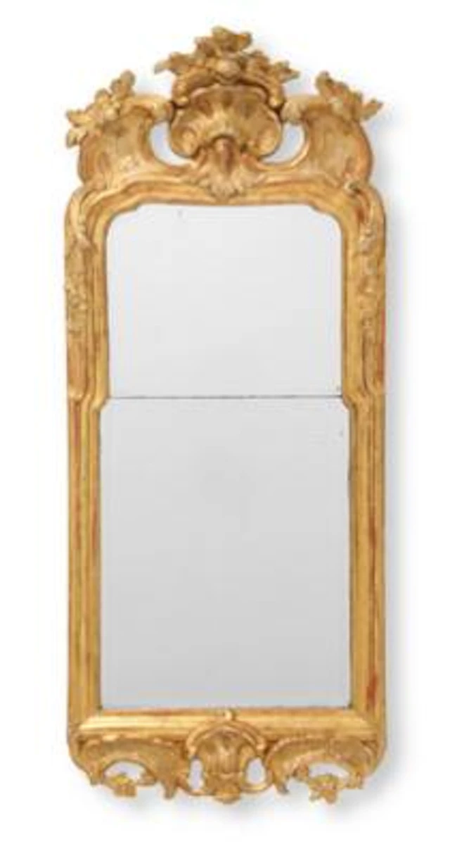 A Swedish Rococo mirror in giltwood frame. The back stamped with Stockholm