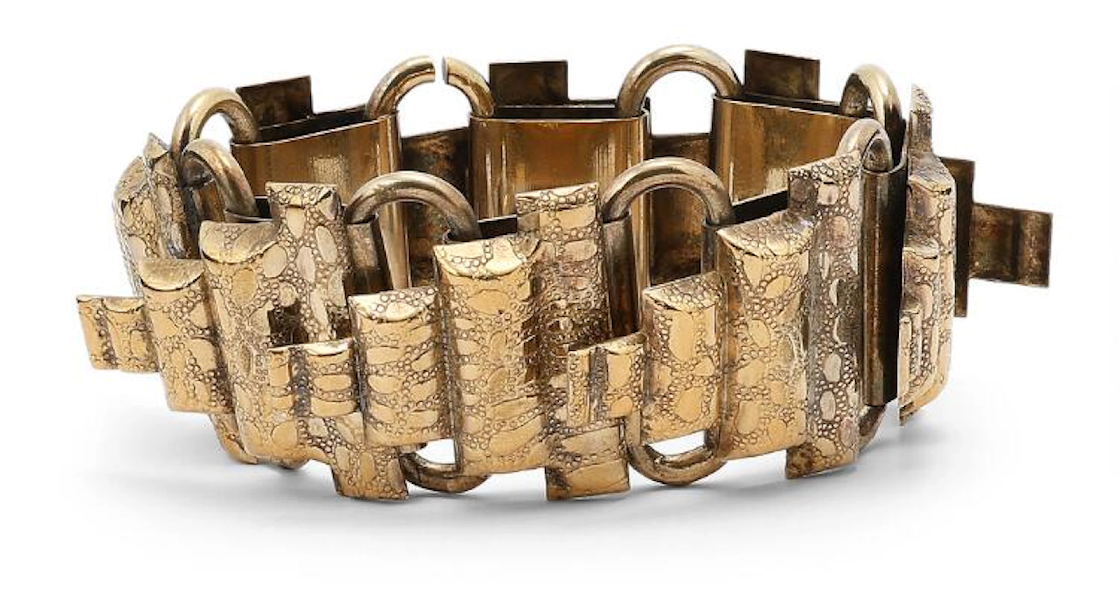Gerda Lynggaard: A bracelet of gold coloured metal. Designed by Monies.