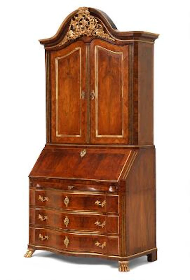 A Danish Rococo walnut and giltwood bureau cabinet. Mid-18th century.