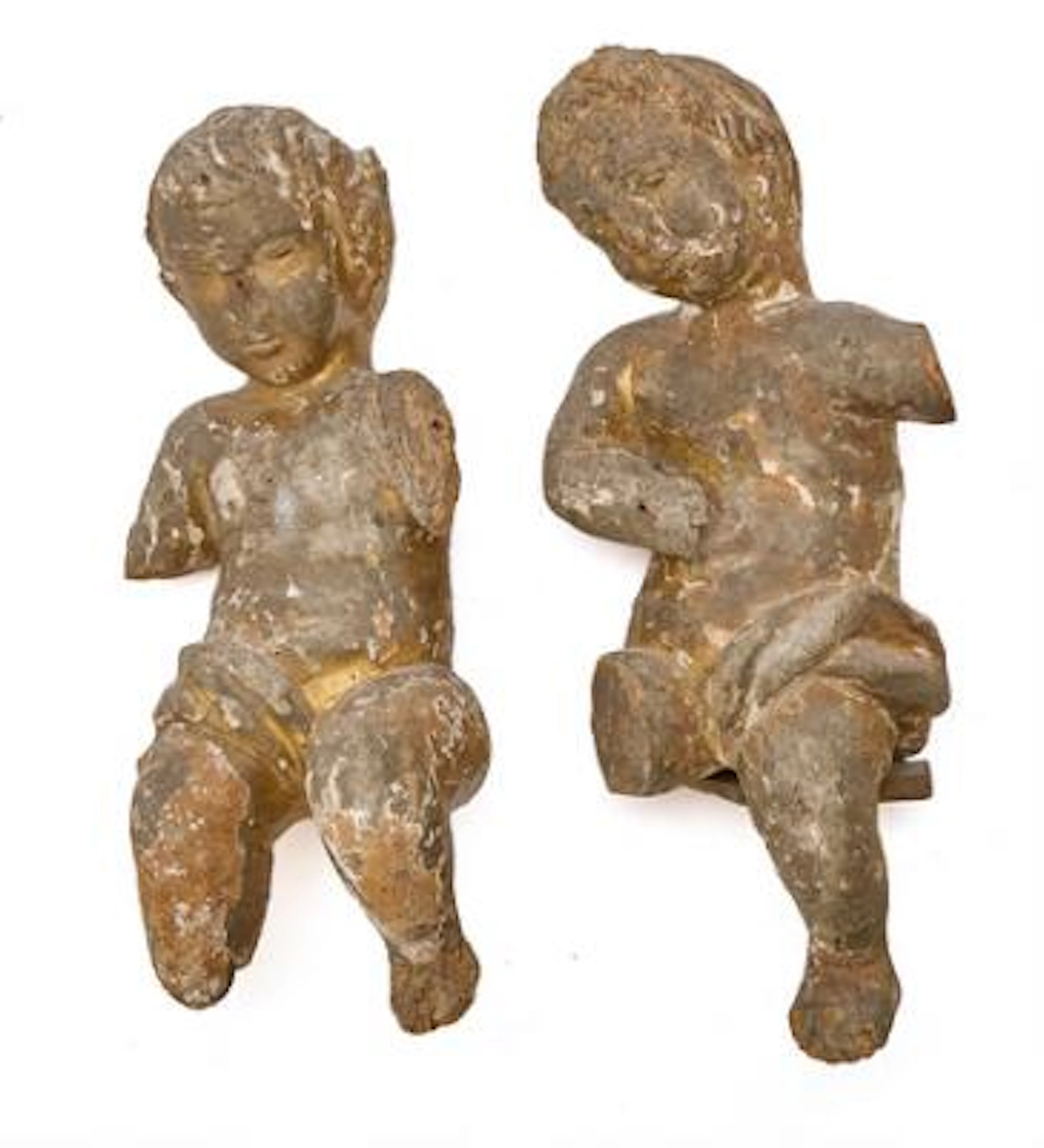 Two Baroque figures of carved wood in the form of putti, with remains