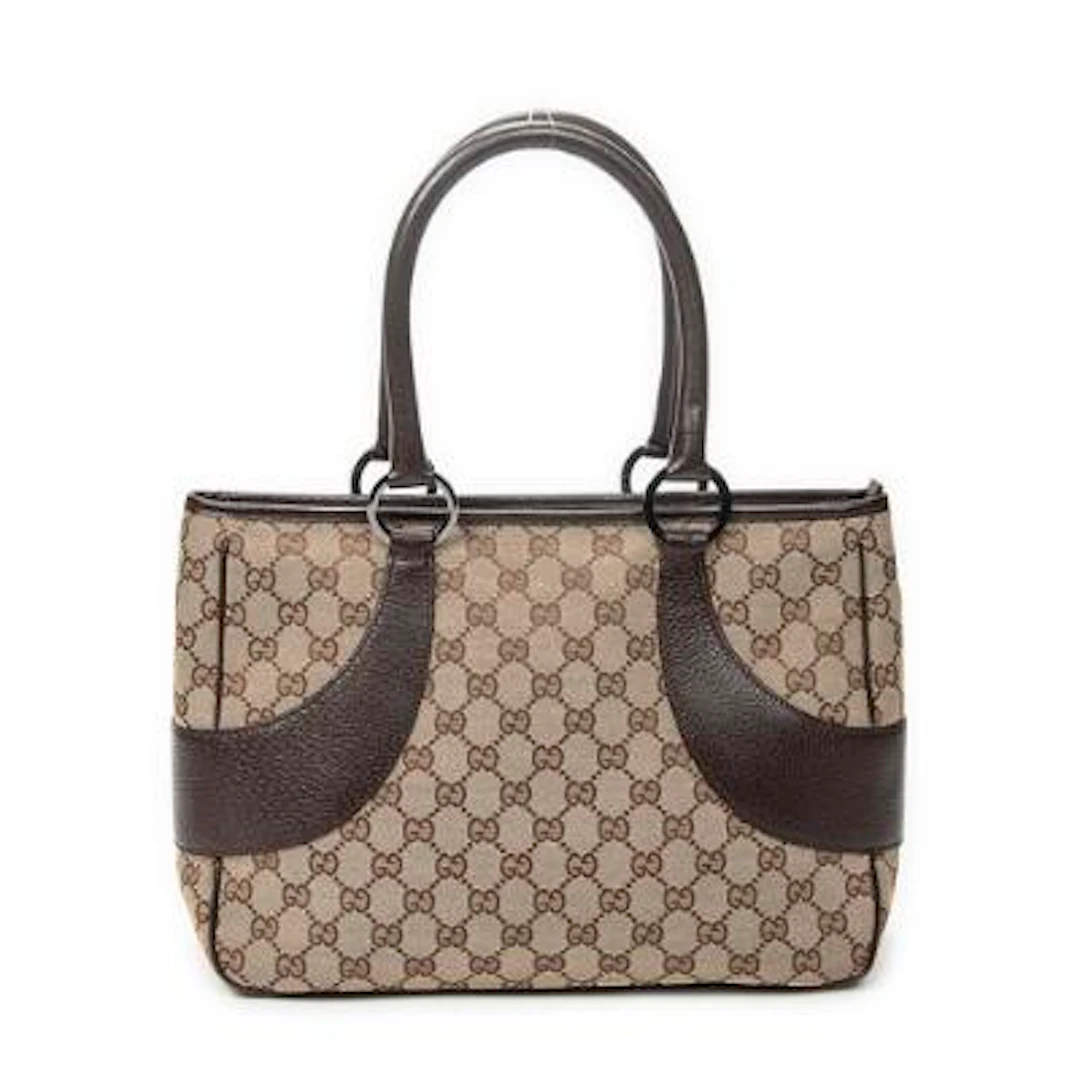 Gucci: A bag of brown monogram canvas with dark brown leather trimmings.