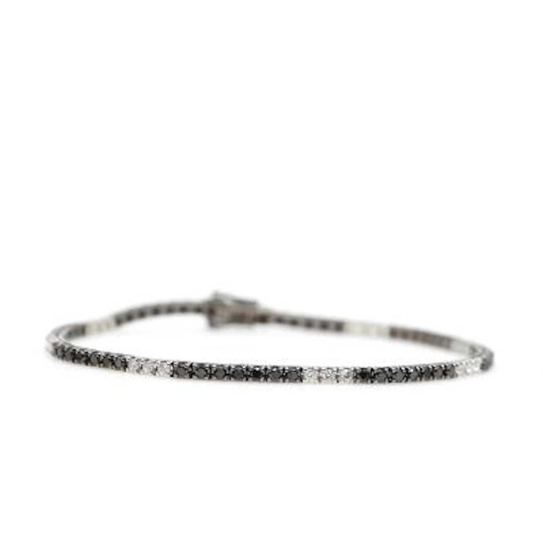 A diamond bracelet set with numerous brilliant-cut black and white