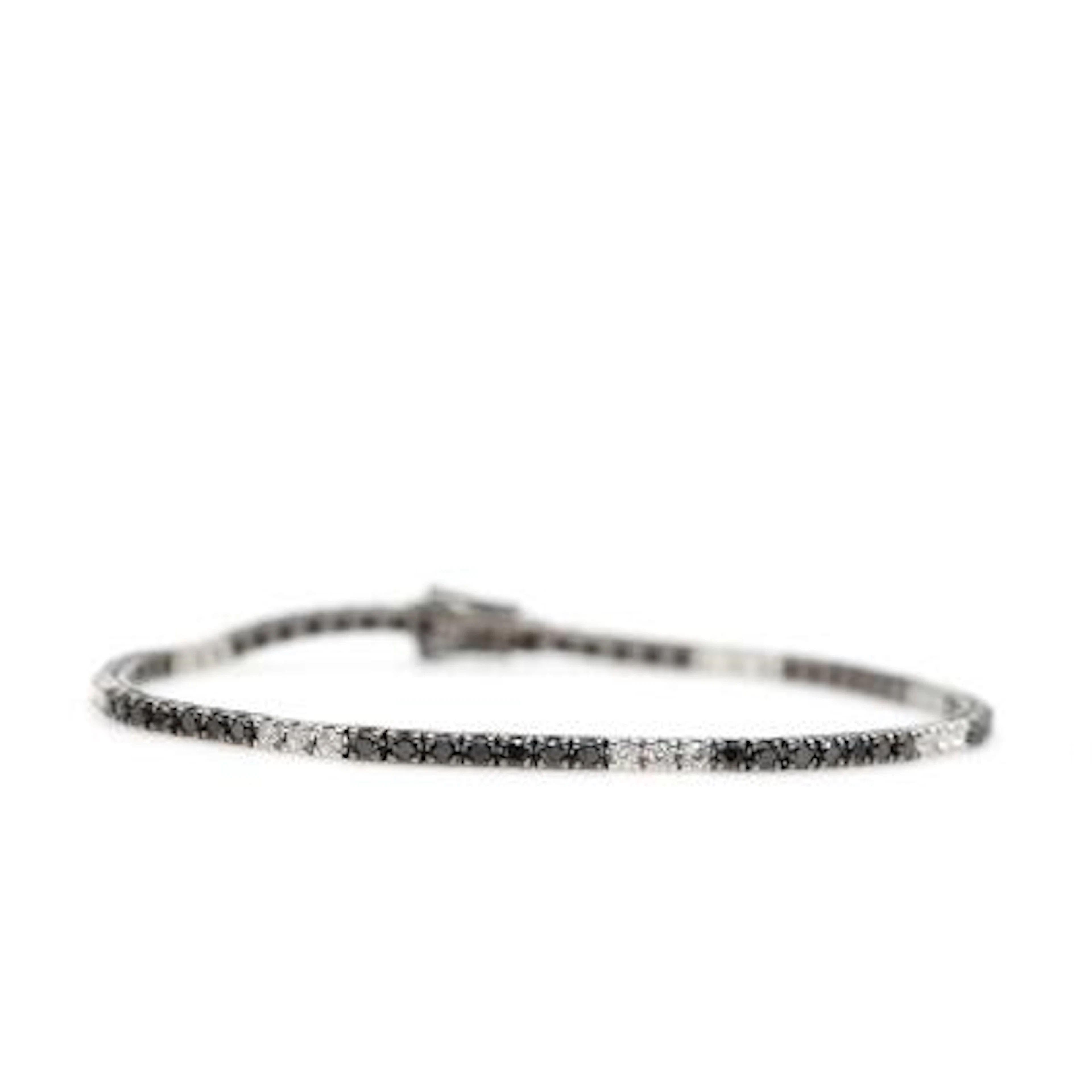 A diamond bracelet set with numerous brilliant-cut black and white