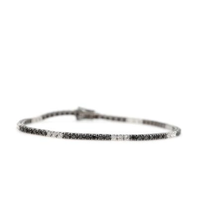 A diamond bracelet set with numerous brilliant-cut black and white