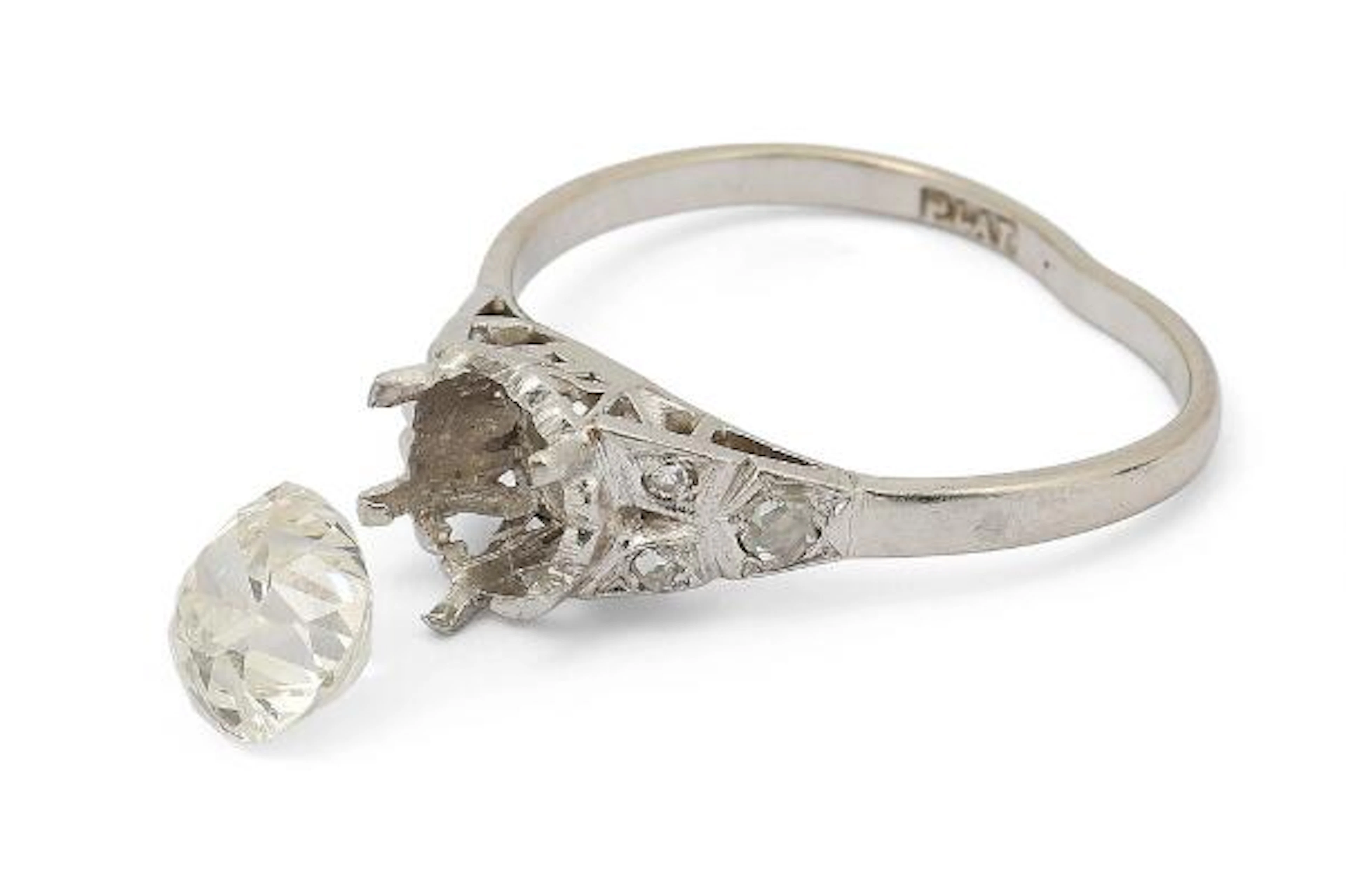 A ring of platinum with a loose cushion-cut diamond weighing app.