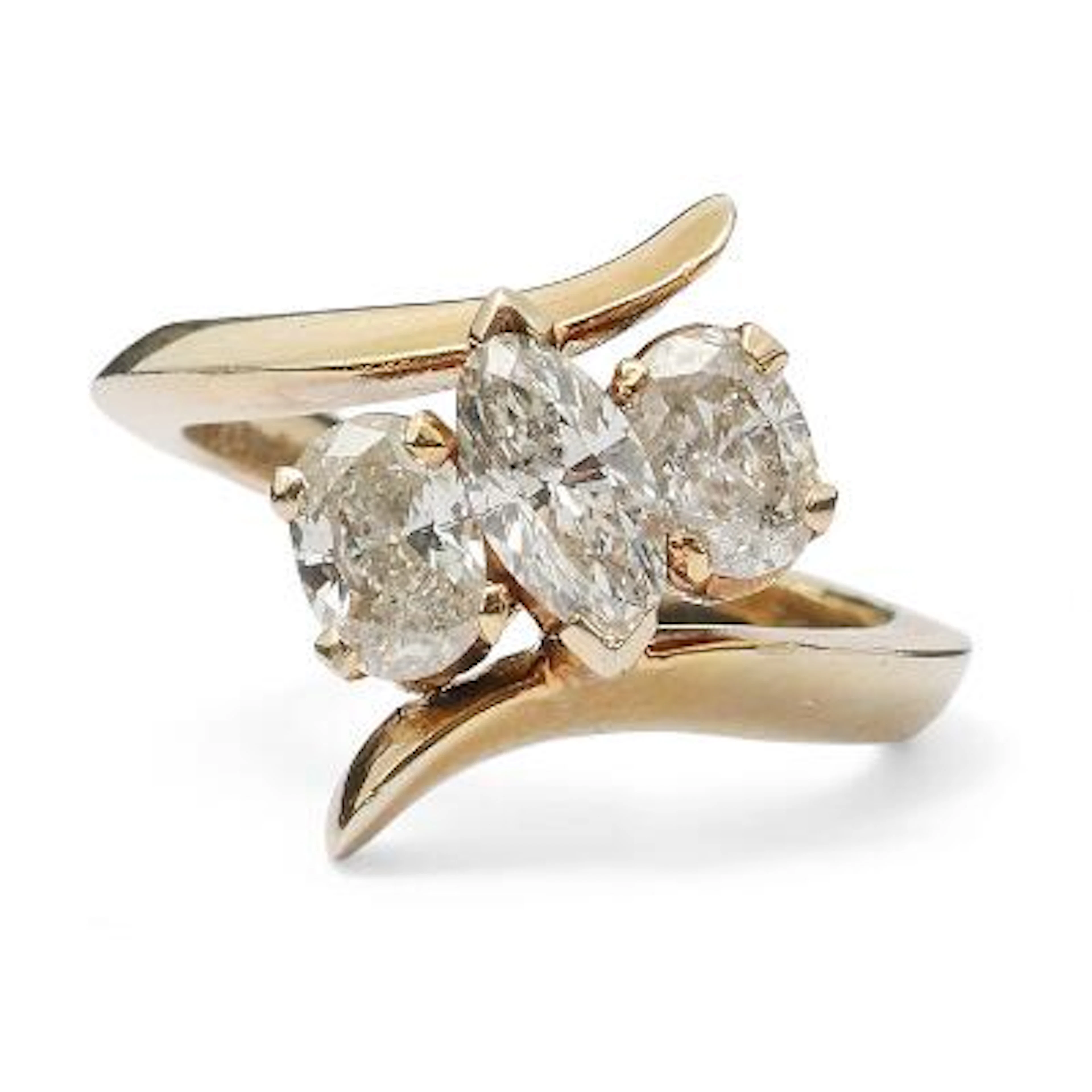 A diamond ring set with a marquise-cut and two oval-cut diamonds