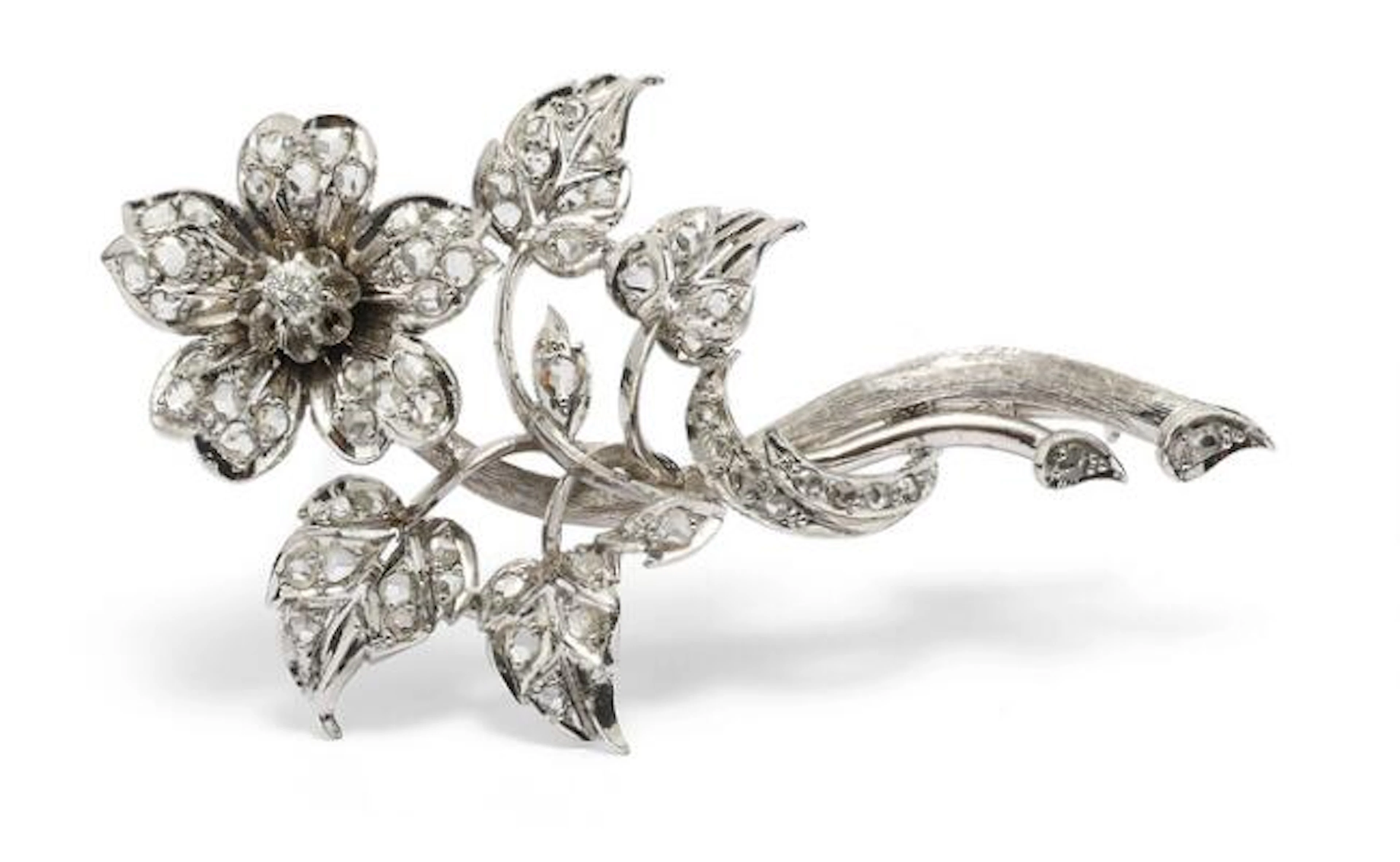 A diamond broch set with numerous diamonds, mounted in 19k white gold.