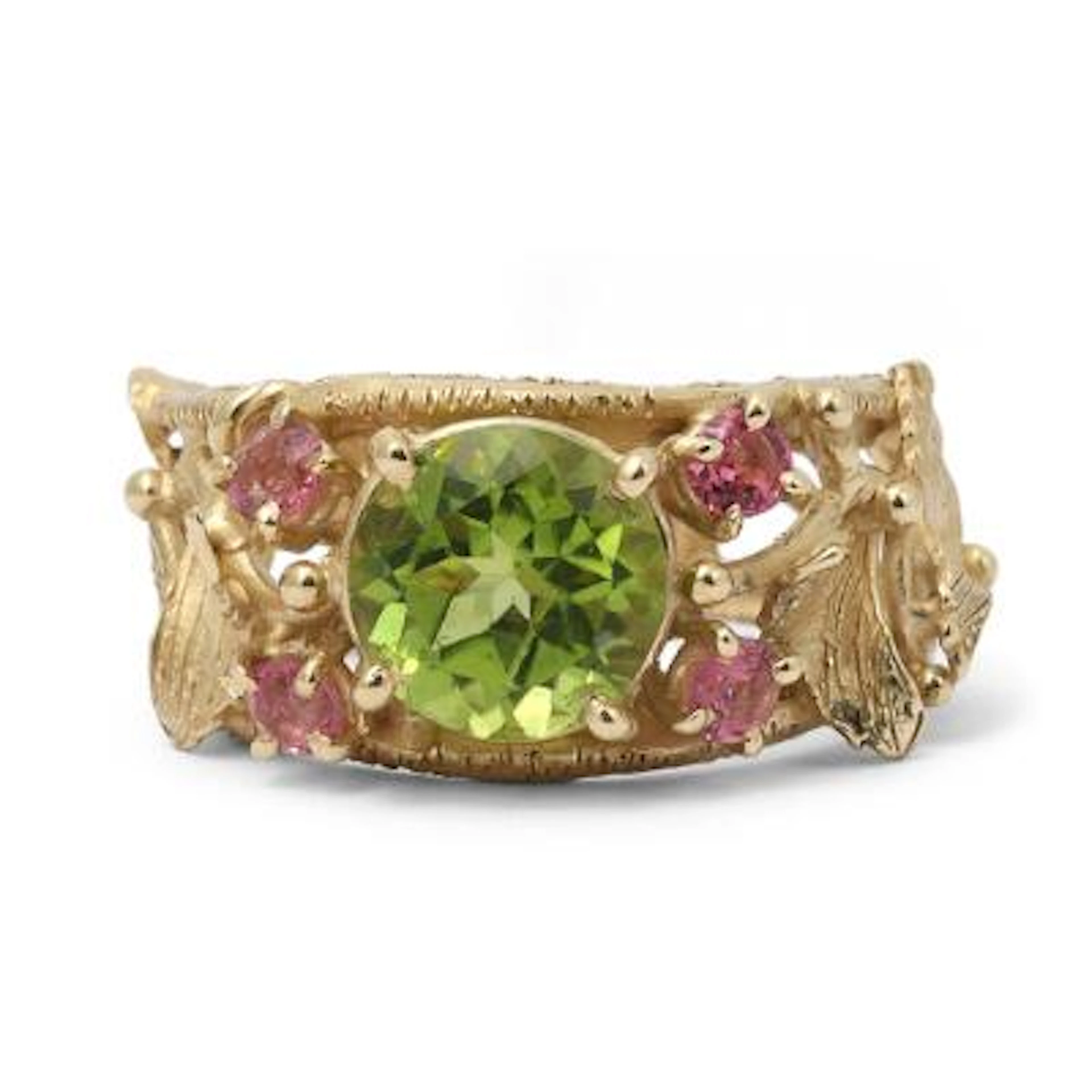 A peridote and tourmaline ring set with a peridote and four pink tourmalines