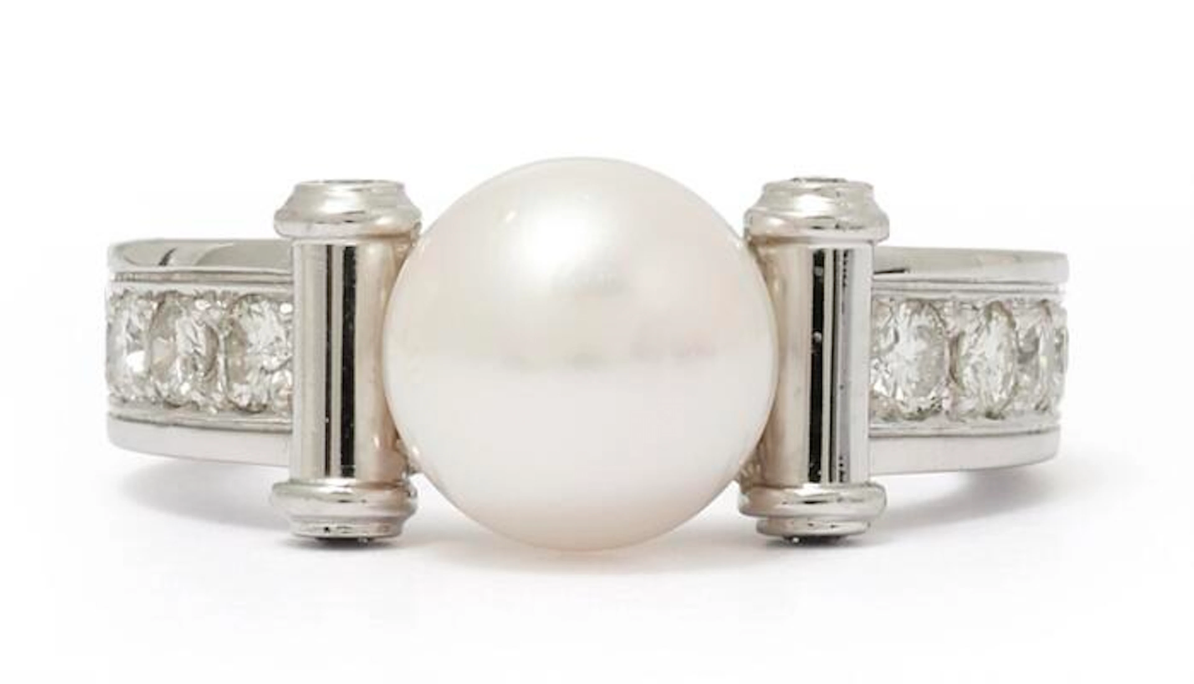 A pearl and diamond ring set with a cultured pearl and numerous diamonds