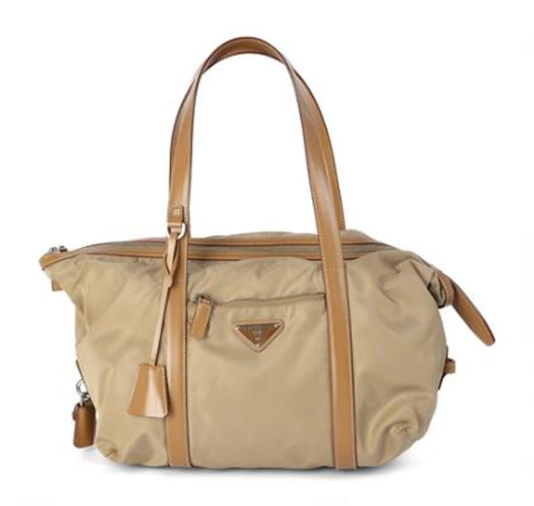 Prada: A bag of beige nylon with light brown leather trimmings and