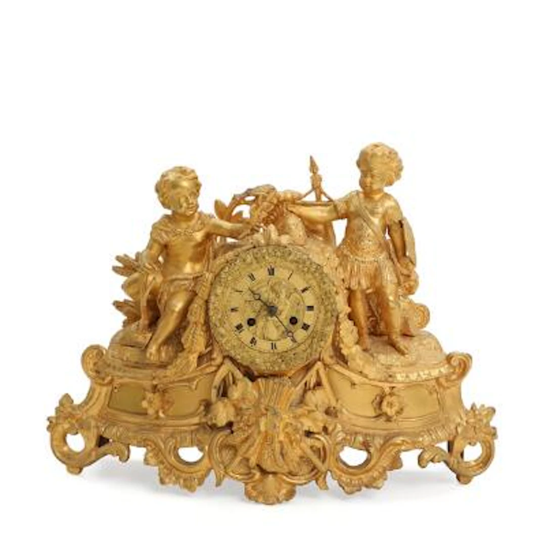 French mantel clock of gilded bronze, decorated with children i Roman