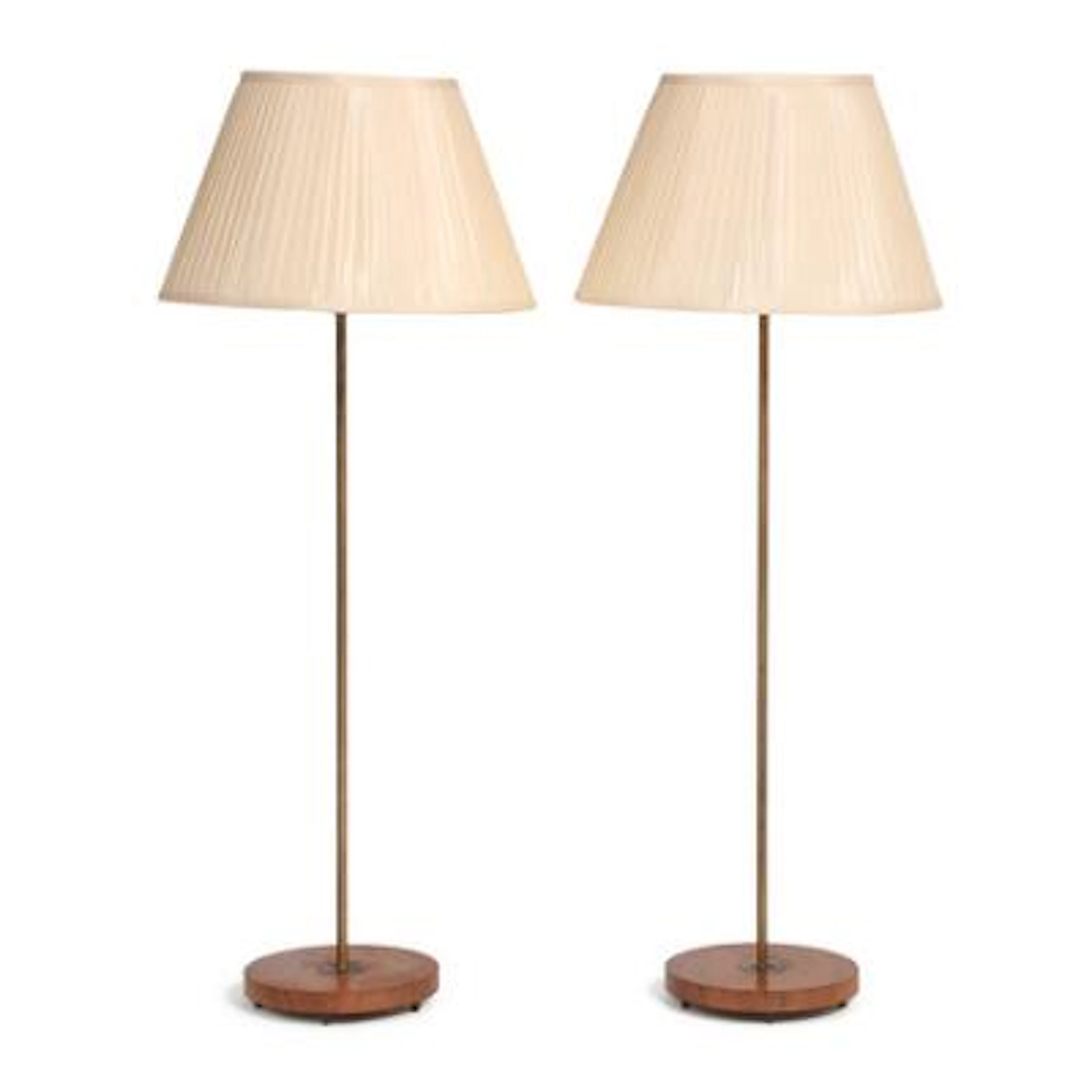 Scandinavian design: A pair of floor lamps with patinated brass stems.