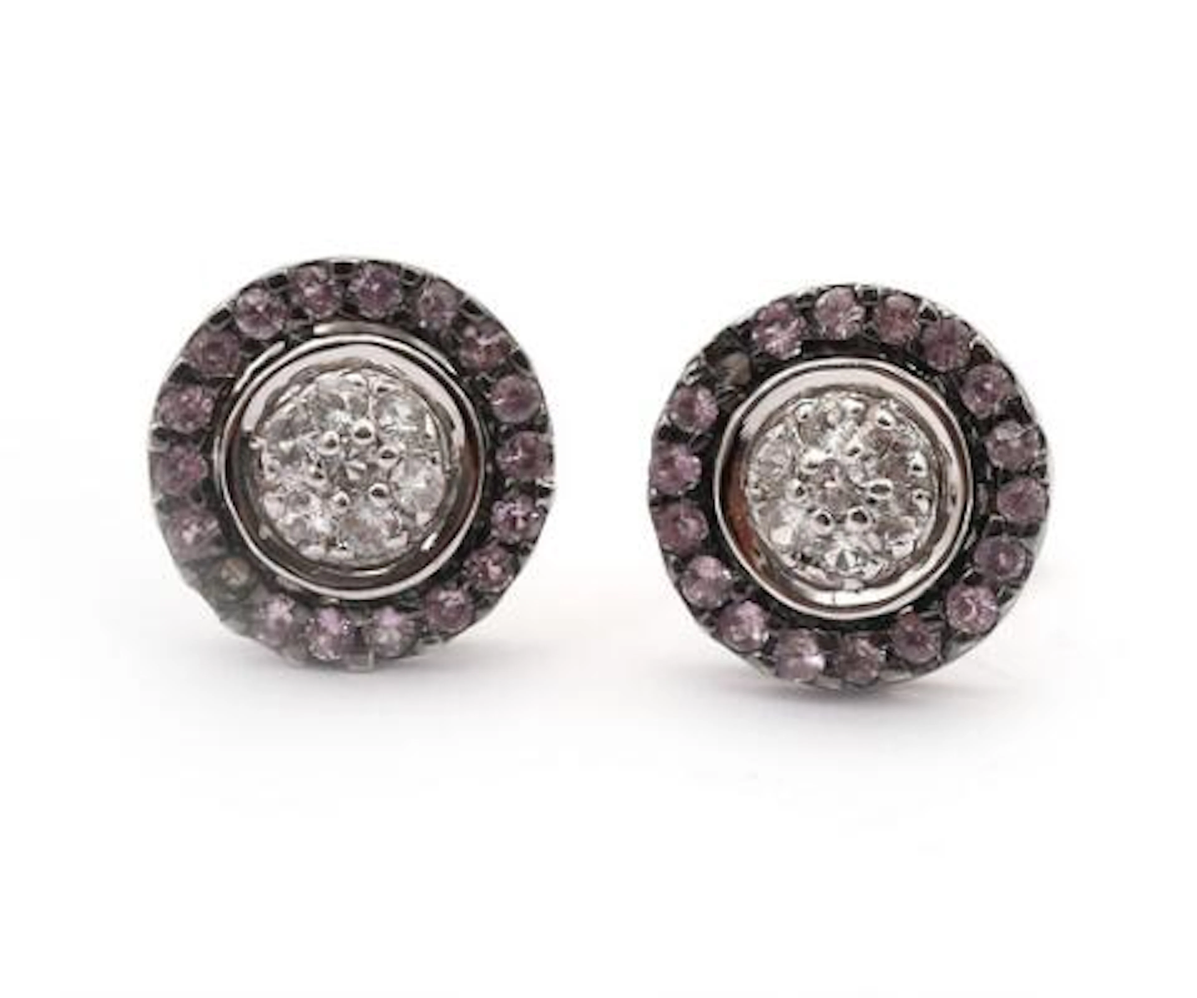 A pair of ear studs set with sapphires and clear stones, mounted in