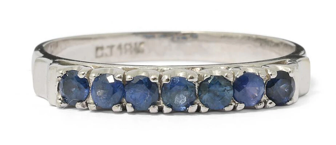 A sapphire ring set with numerous circular-cut sapphires, mounted