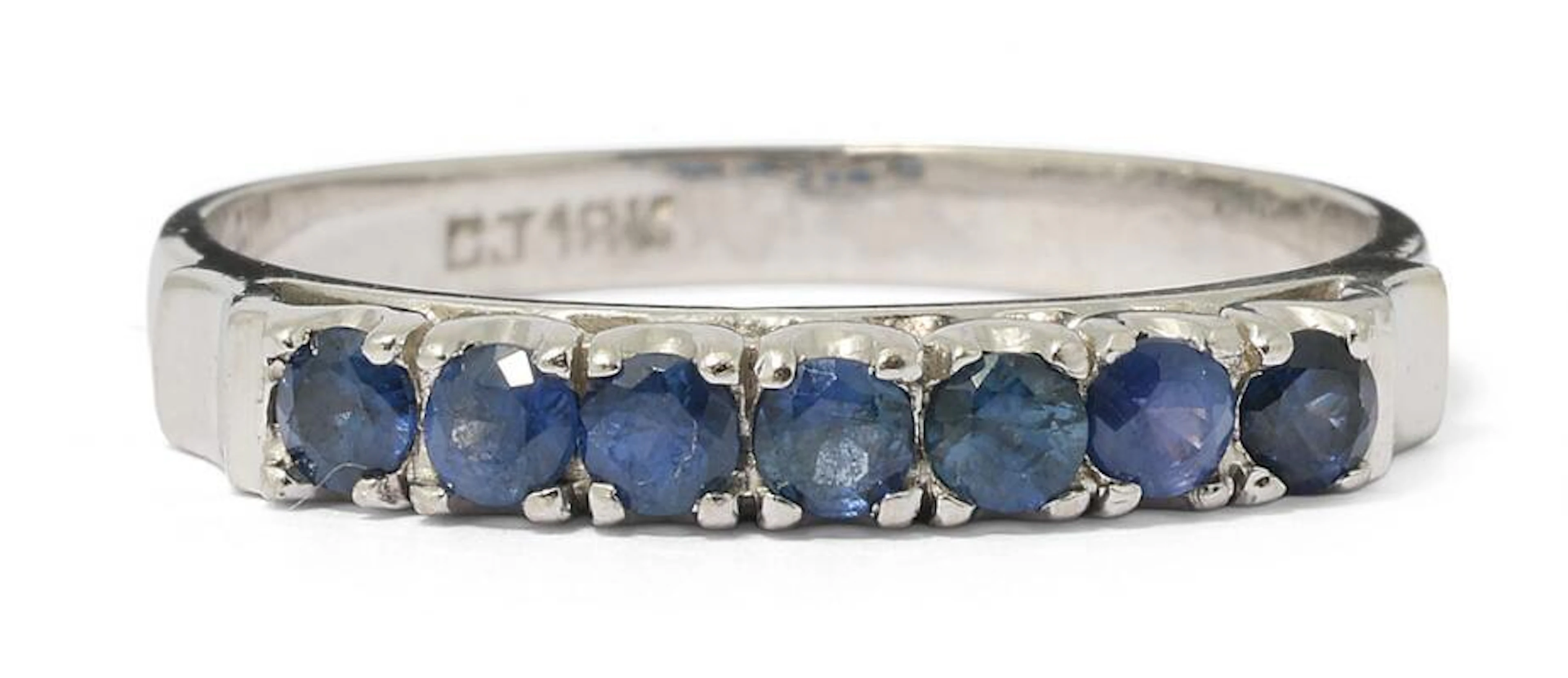 A sapphire ring set with numerous circular-cut sapphires, mounted