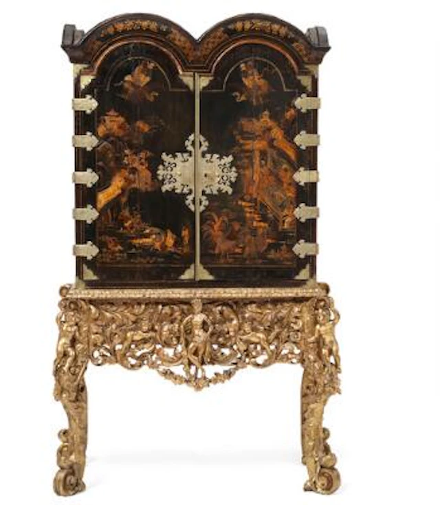 A Queen Anne black japanned cabinet on silvered stand. England, c.