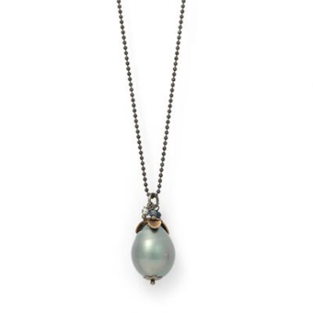 A necklace set with a pearl pendant set wih crystal beads, mounted