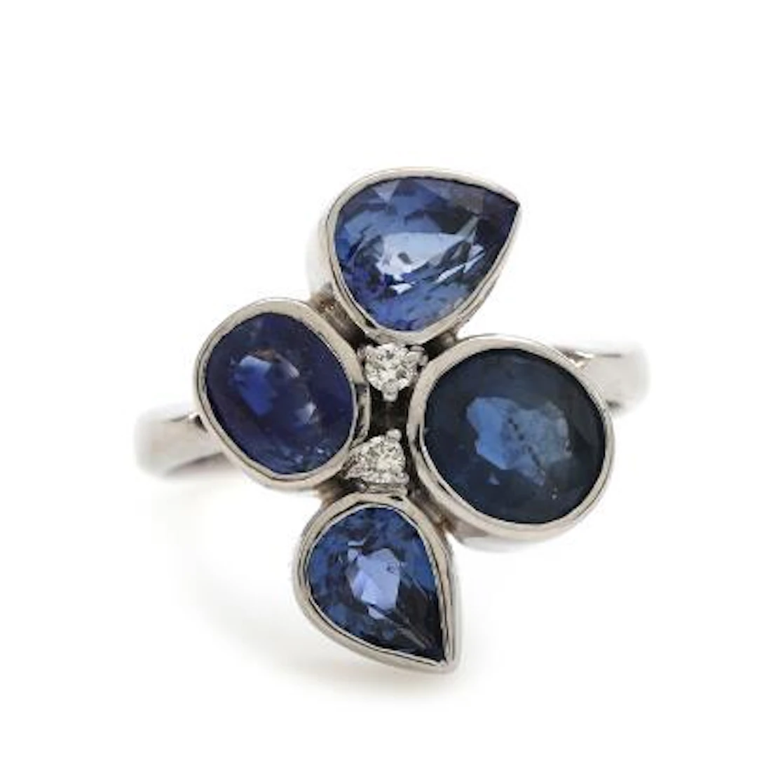 A sapphire and diamond ring set with faceted sapphires and brilliant-cut