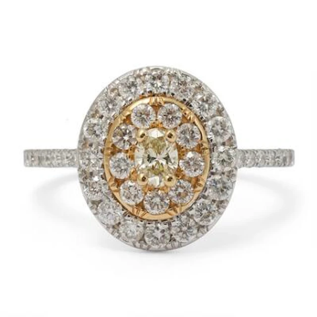 A diamond ring set with a yellow diamond encircled by numerous diamonds