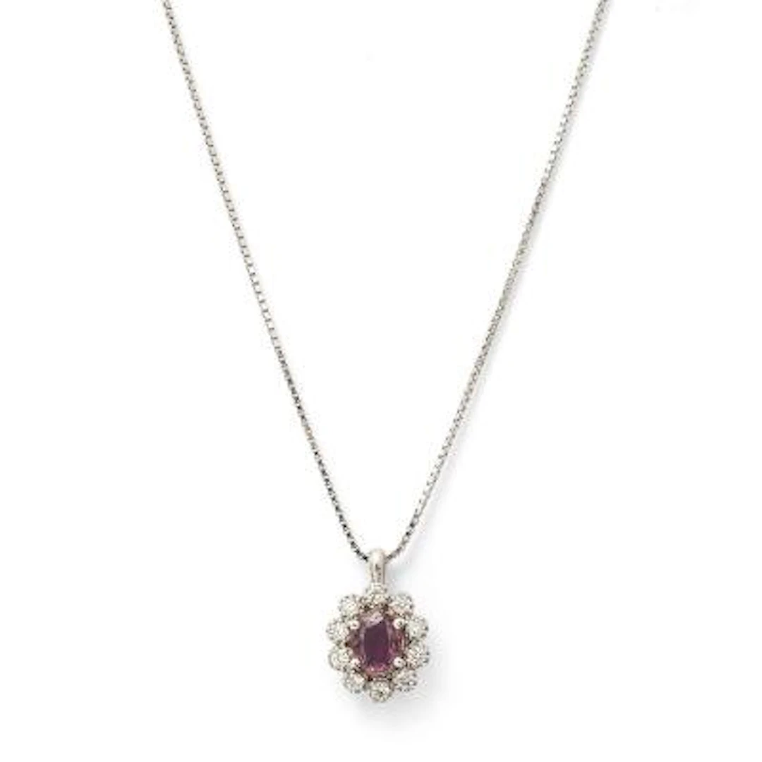 A ruby and diamond necklace set with a ruby encircled by diamonds