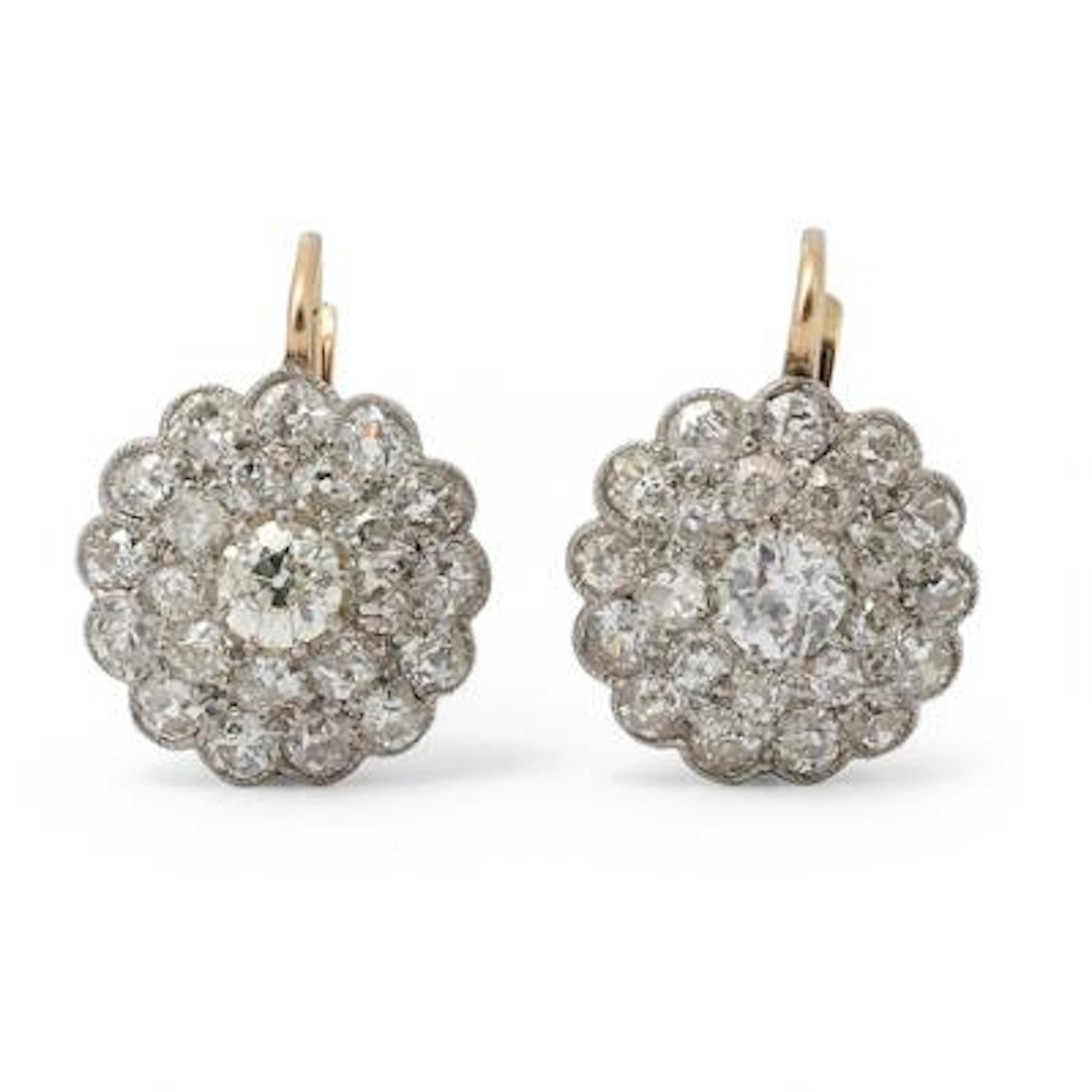A pair of diamond ear studs each set with diamonds, mounted in 14k