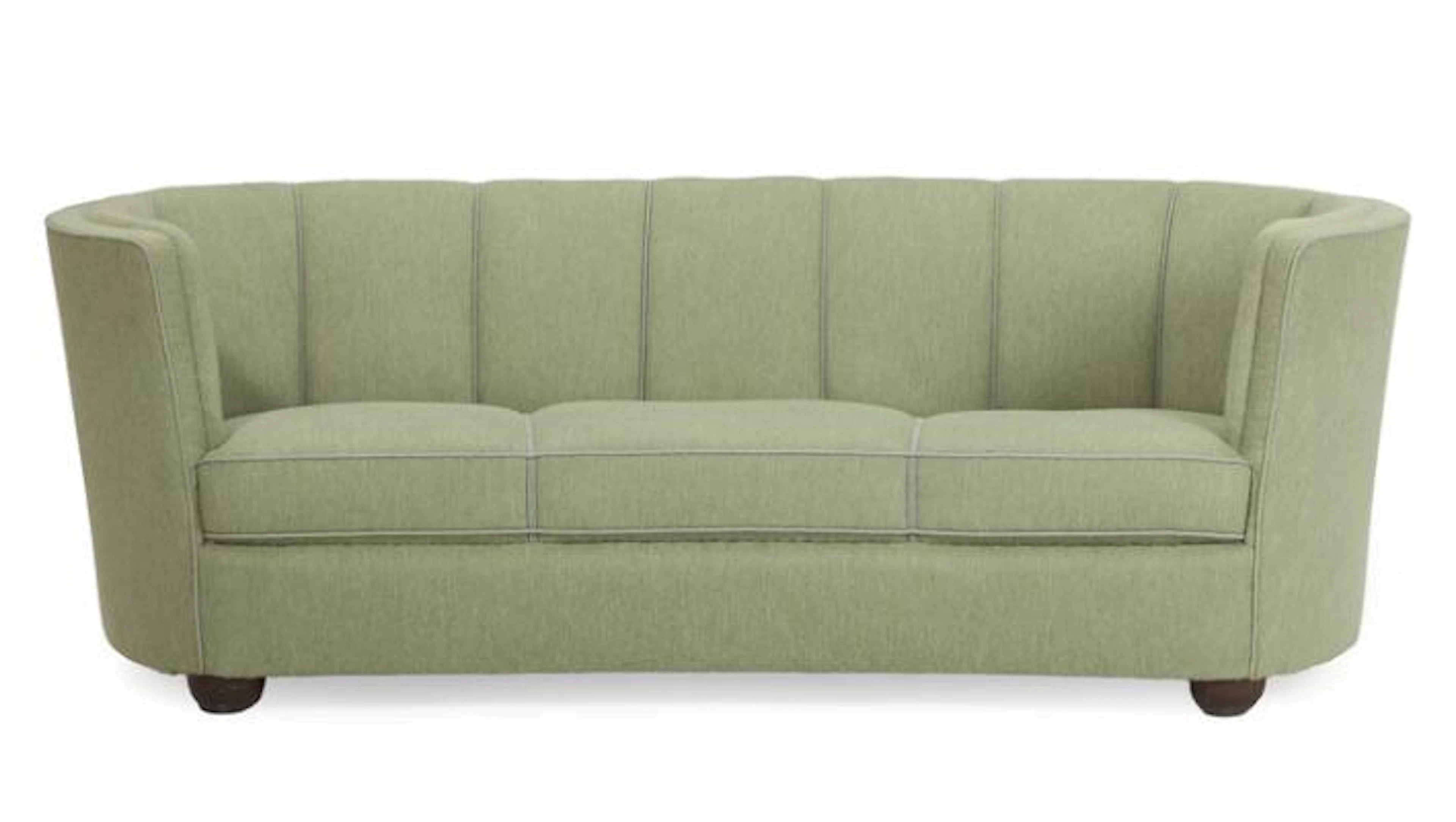 Danish design: A curved three seater sofa upholstered with light green