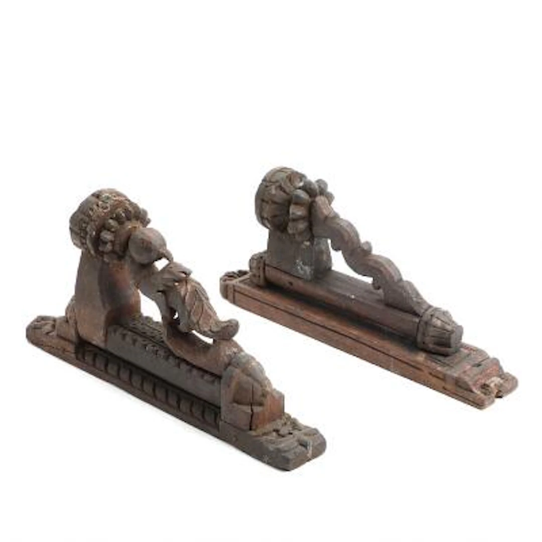 Two Colonial wall sconces of carved wood with movable light arms.