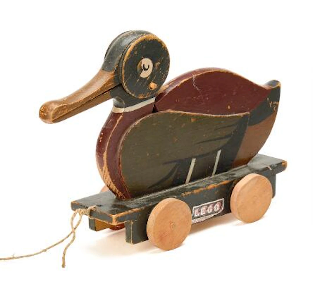 A paint wooden pull duck on wheels with sound and moveable beak, marked