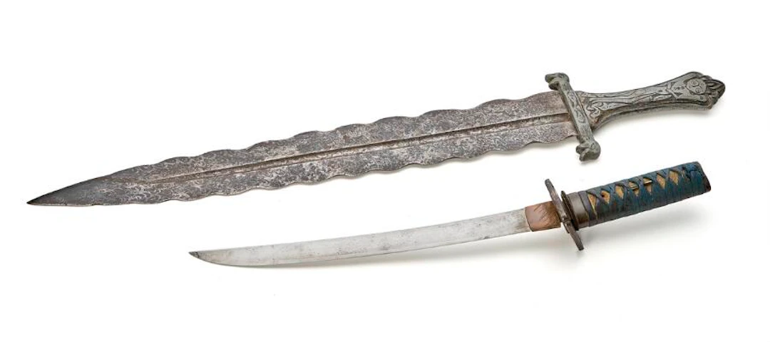 A Japanese Wakizashi in its scabbard, as well as a fantasy sword from...?