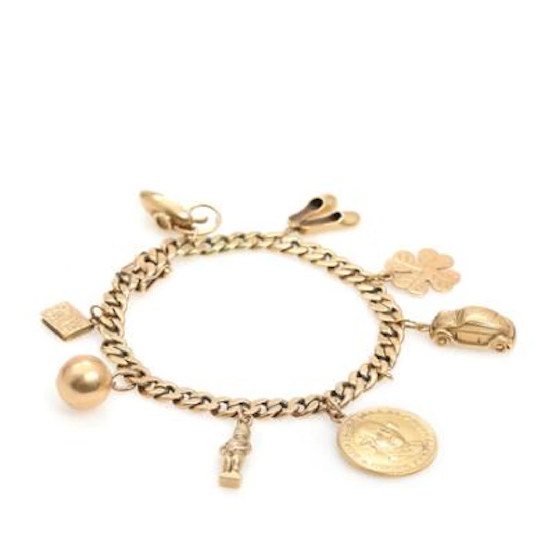 A charm bracelet of 14k gold set with numerous charms. Weight app.