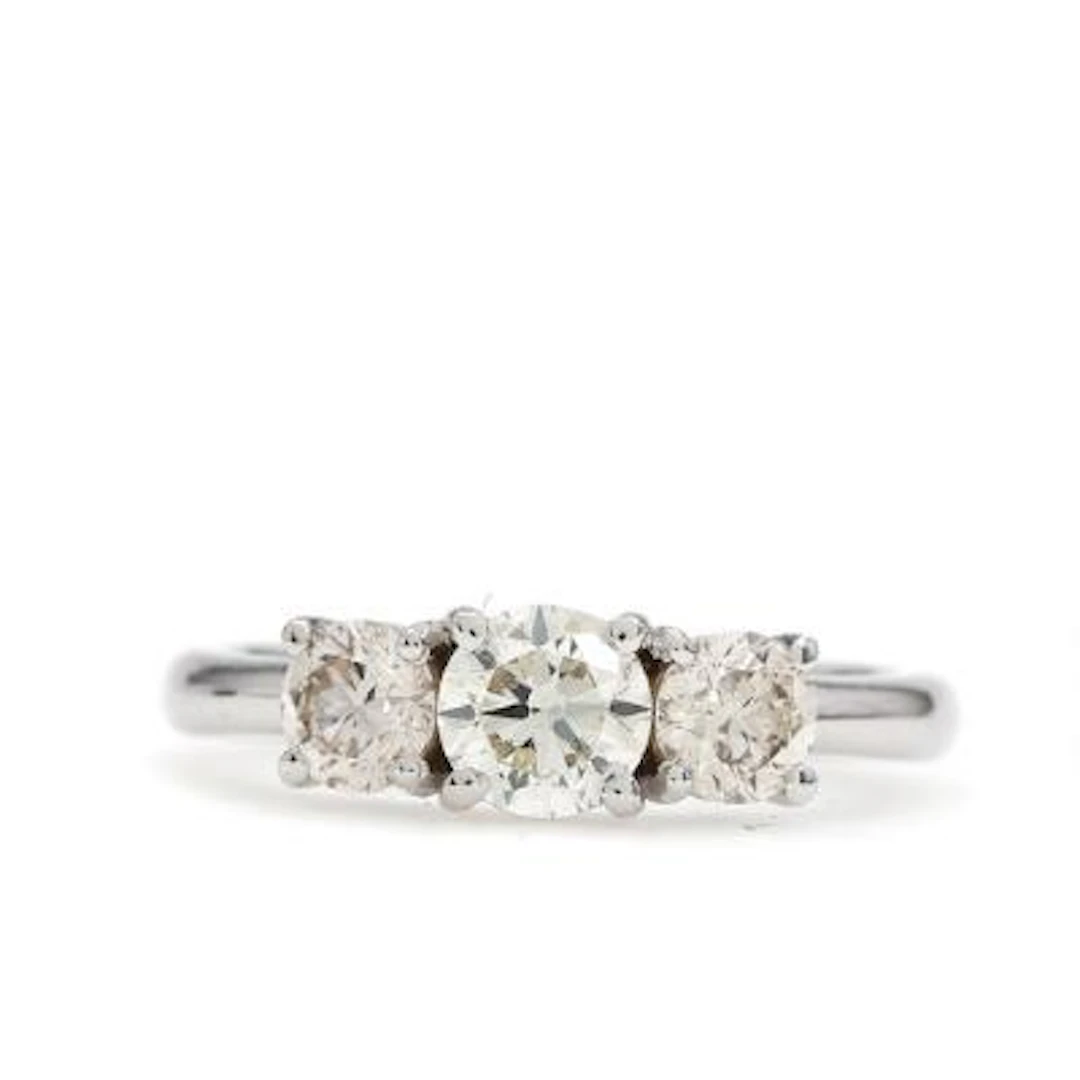 A diamond ring set with three brilliant-cut diamonds weighing a total