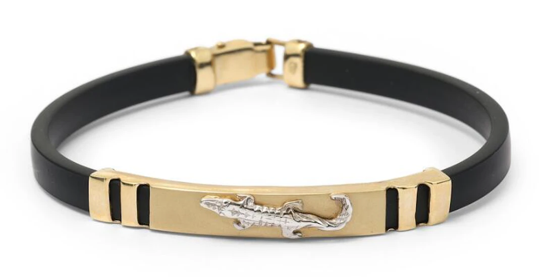 A bracelet of black rubber and 14k gold and white gold. Weight app.