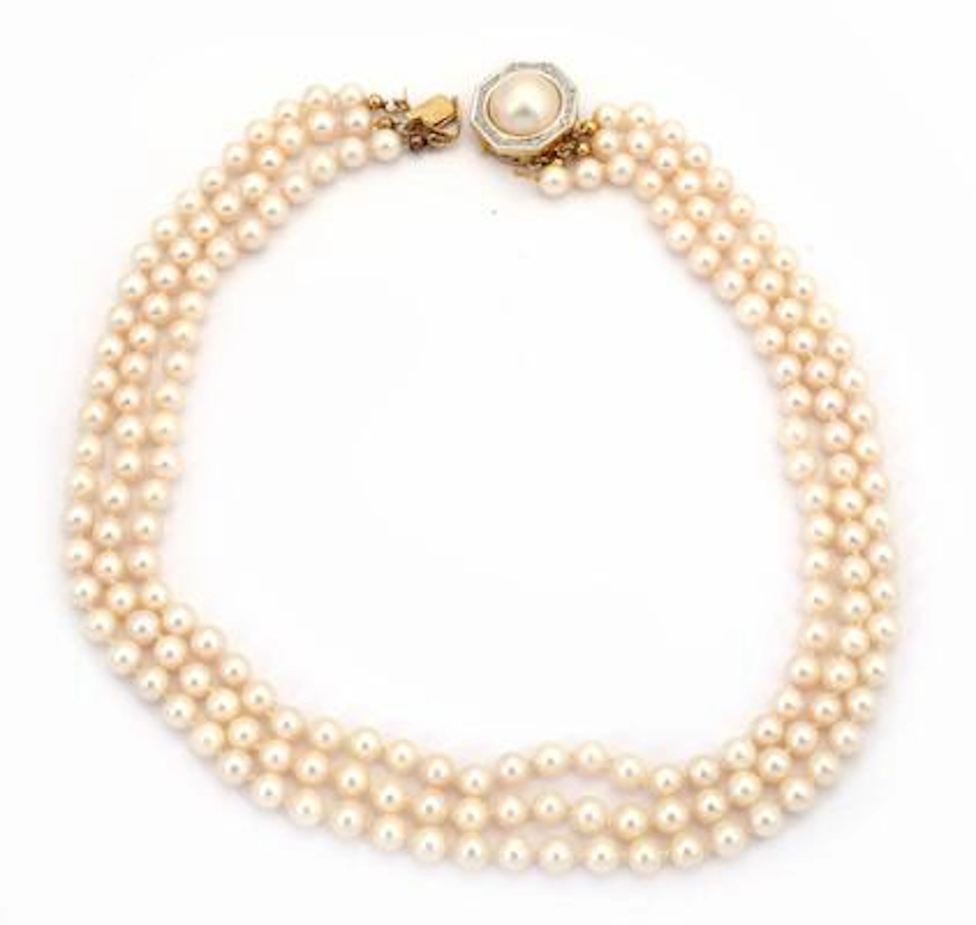 A three-strand pearl necklace set with numerous cultured pearls and