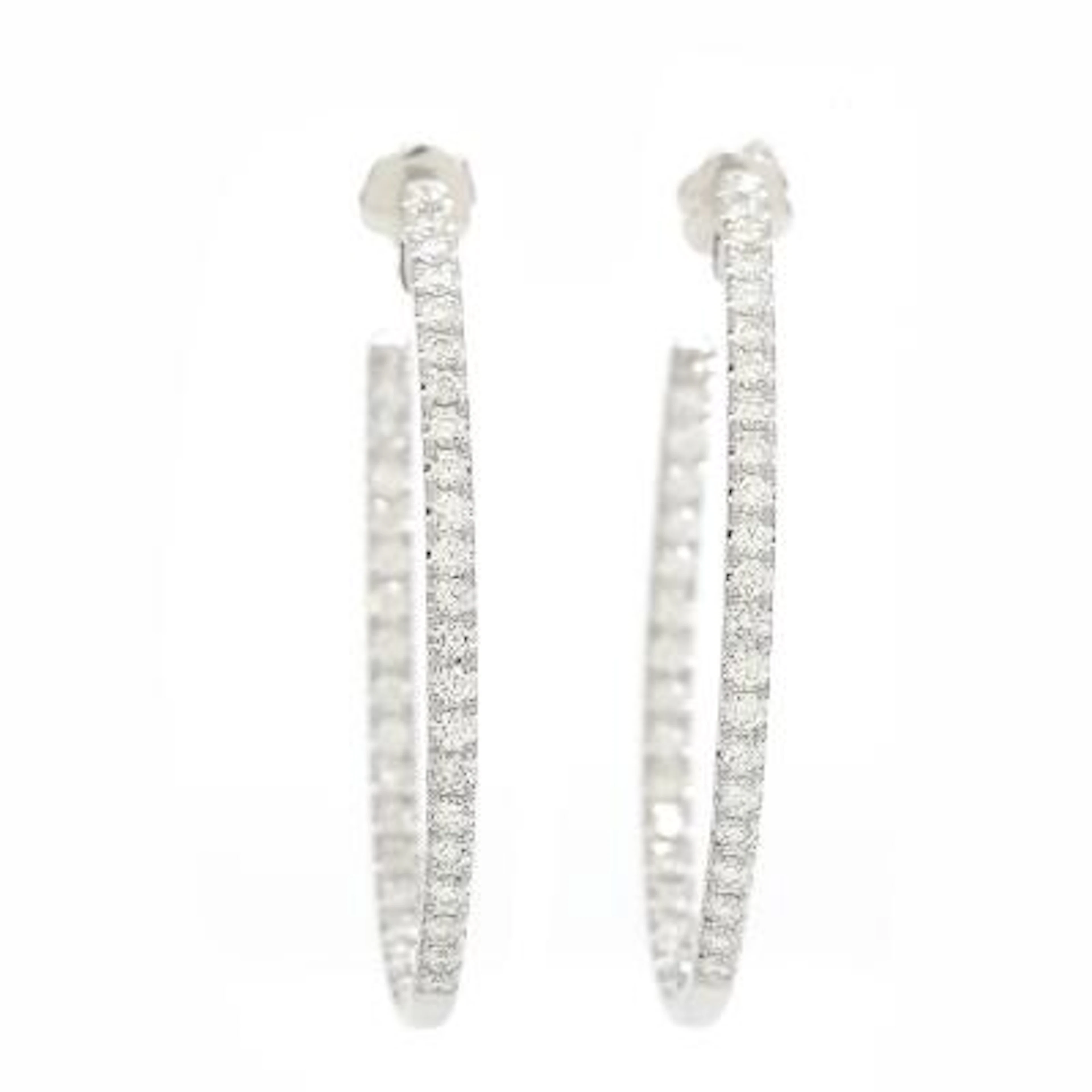 A pair of diamond ear hoops set with numerous brilliant-cut diamonds