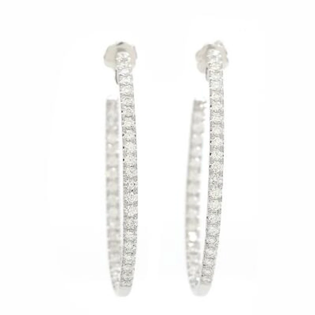 A pair of diamond ear hoops set with numerous brilliant-cut diamonds