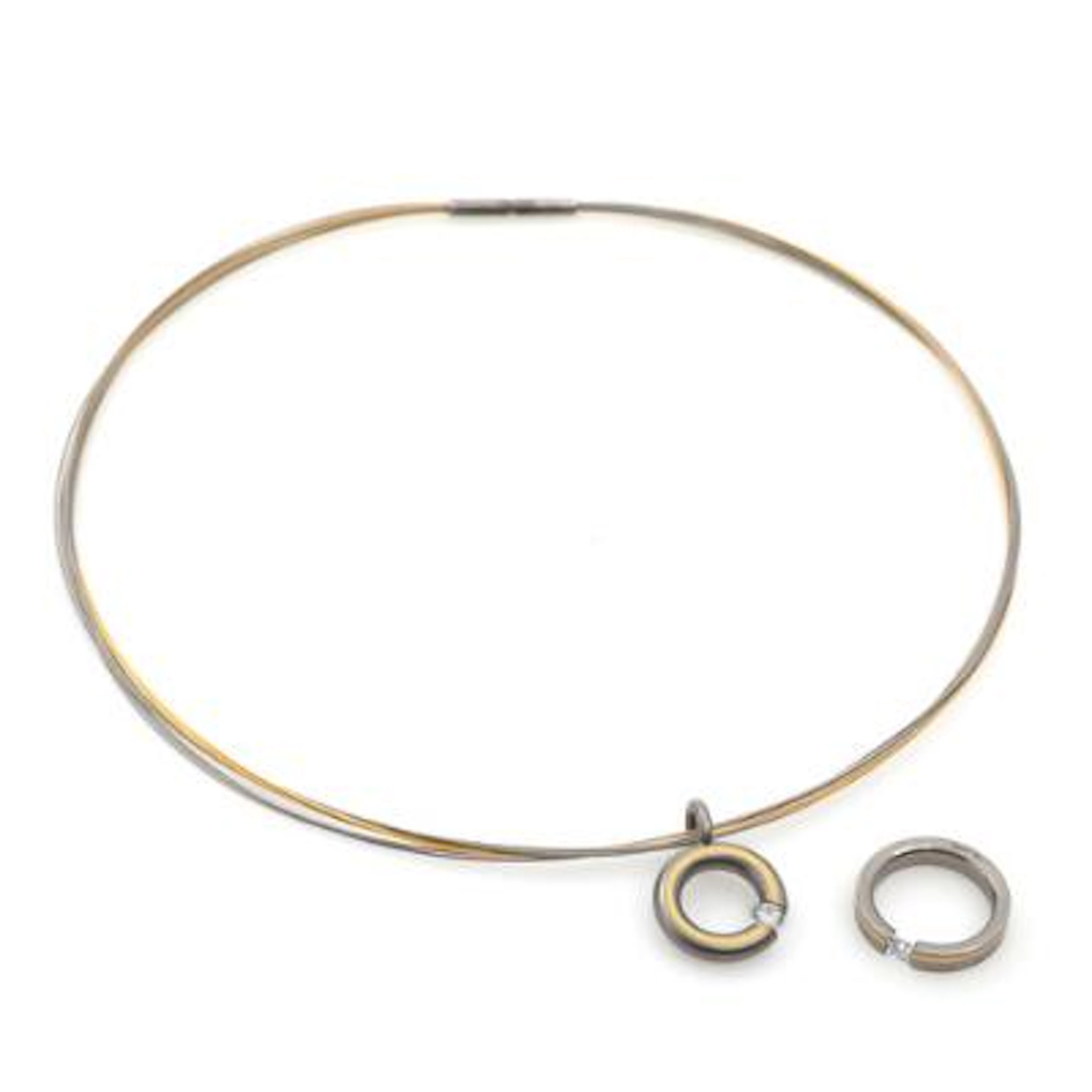 A necklace and ring set with faceted clear stones, mounted in titanium