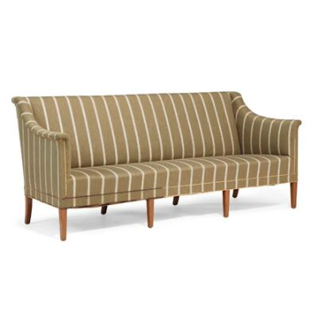Kaare Klint: Kaare KlinThree seater sofa with mahogany legs. Upholstered