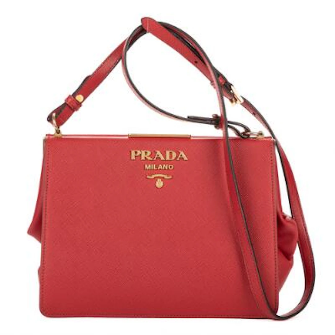 Prada: A "Frame Bag" in red Saffiano-leather with gold-tone hardware.