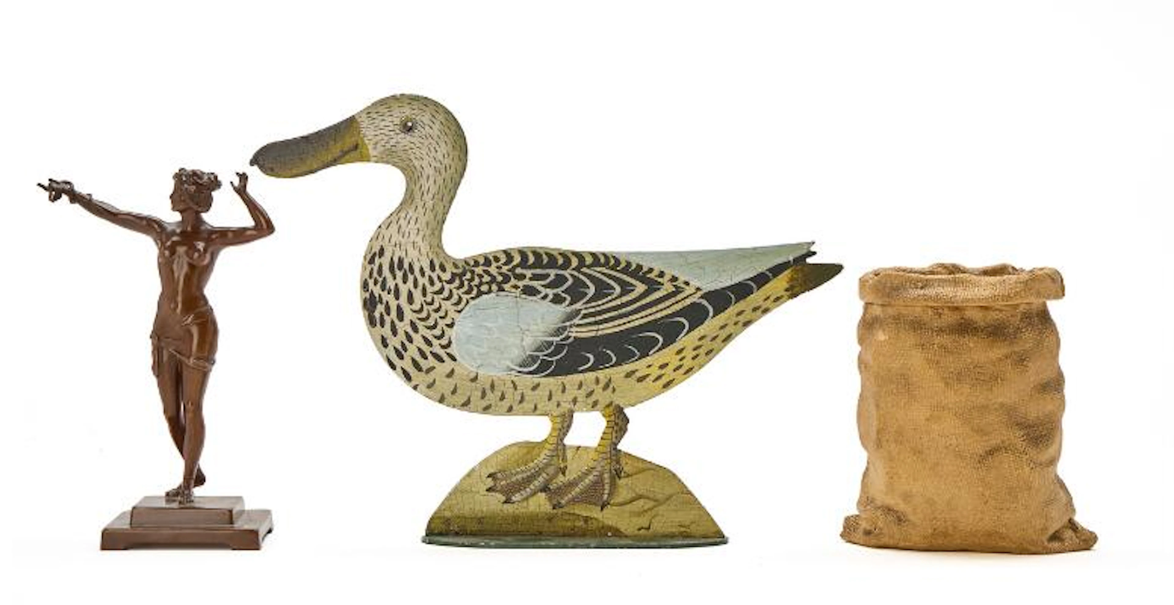A terracotte jar and cover sphed as a bag of money, a bronze figurine