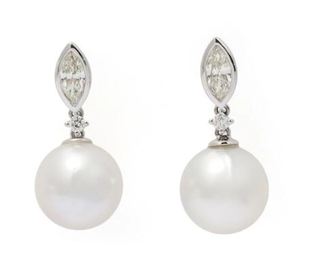 A pair of pearl and diamond ear pendants each set with a pearl and