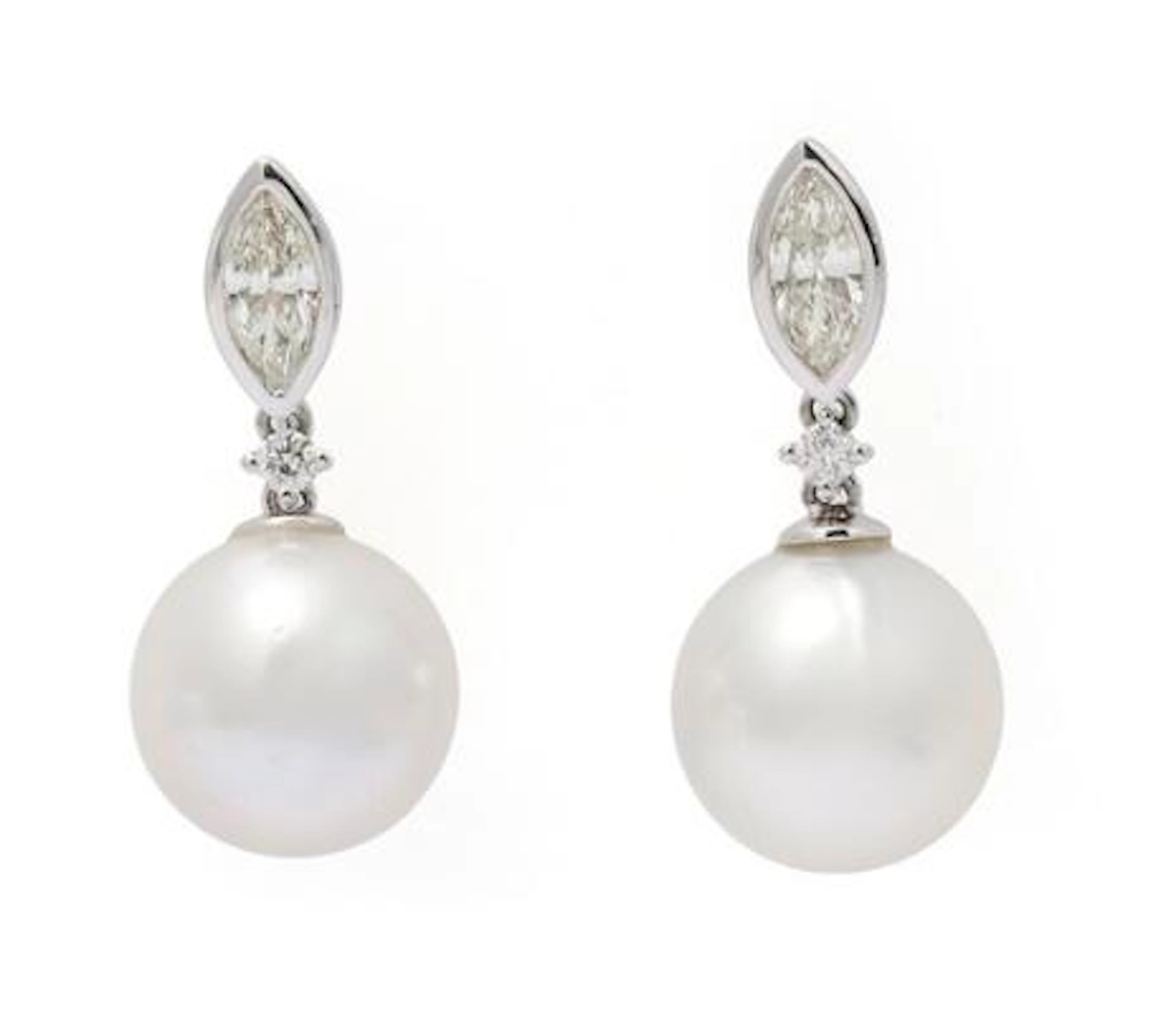 A pair of pearl and diamond ear pendants each set with a pearl and