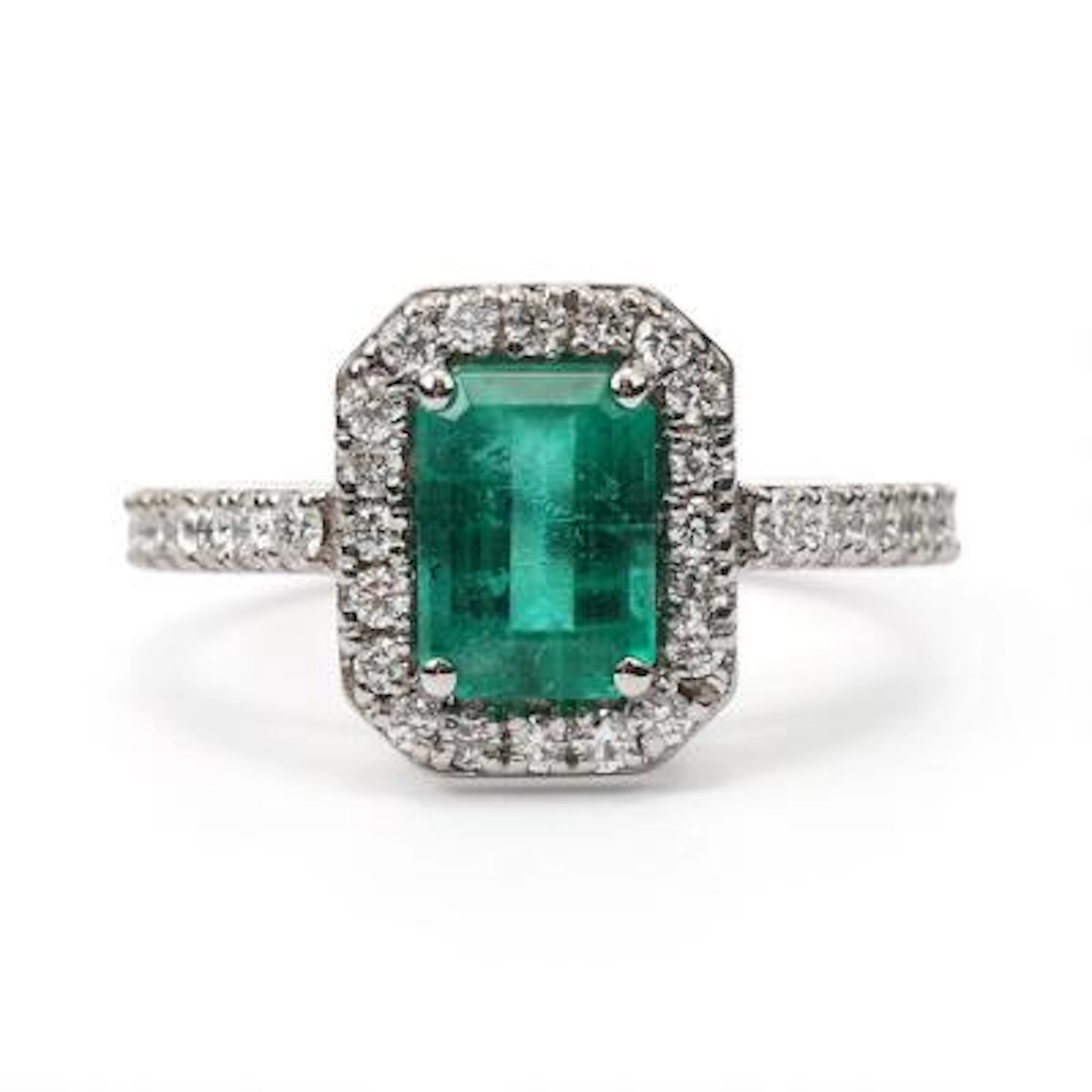 An emerald and diamond ring set with an emerald and diamonds, mounted