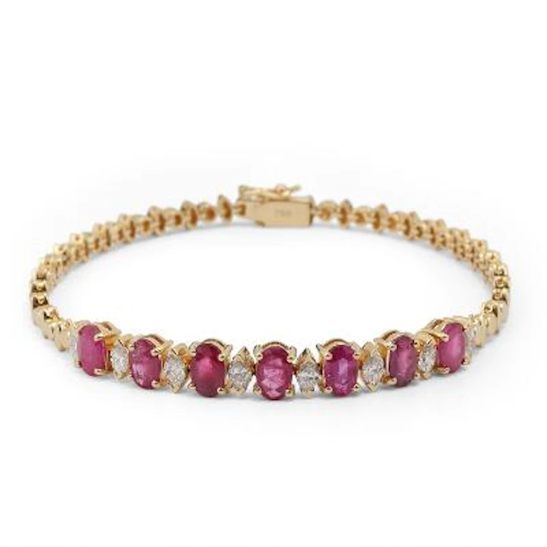 A ruby and diamond bracelet set with rubies and diamonds mounted in