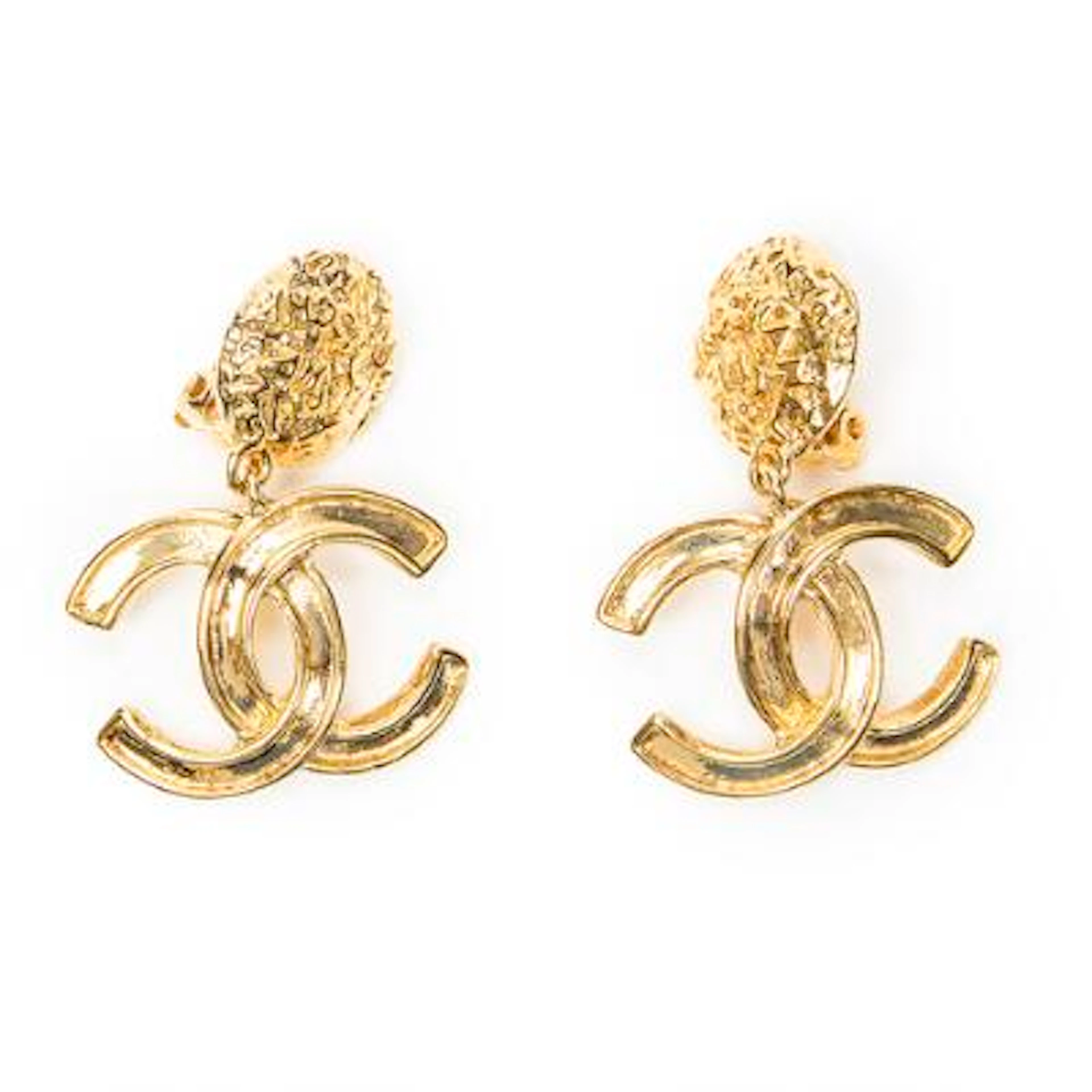 Chanel: A pair of earclips of gold-toned metal each set with a CC