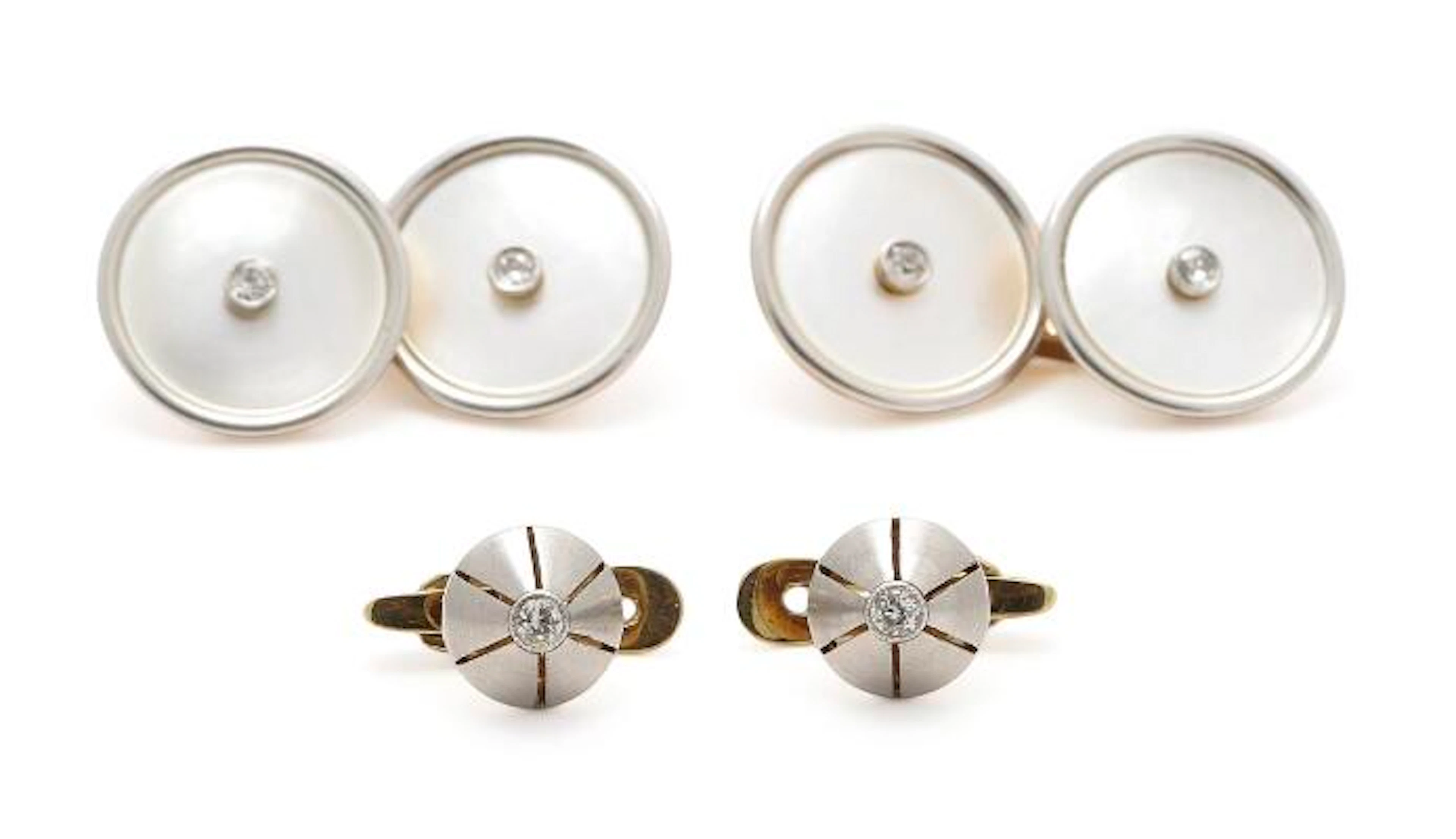 A pair of cufflinks and two dress studs partly set with mother of