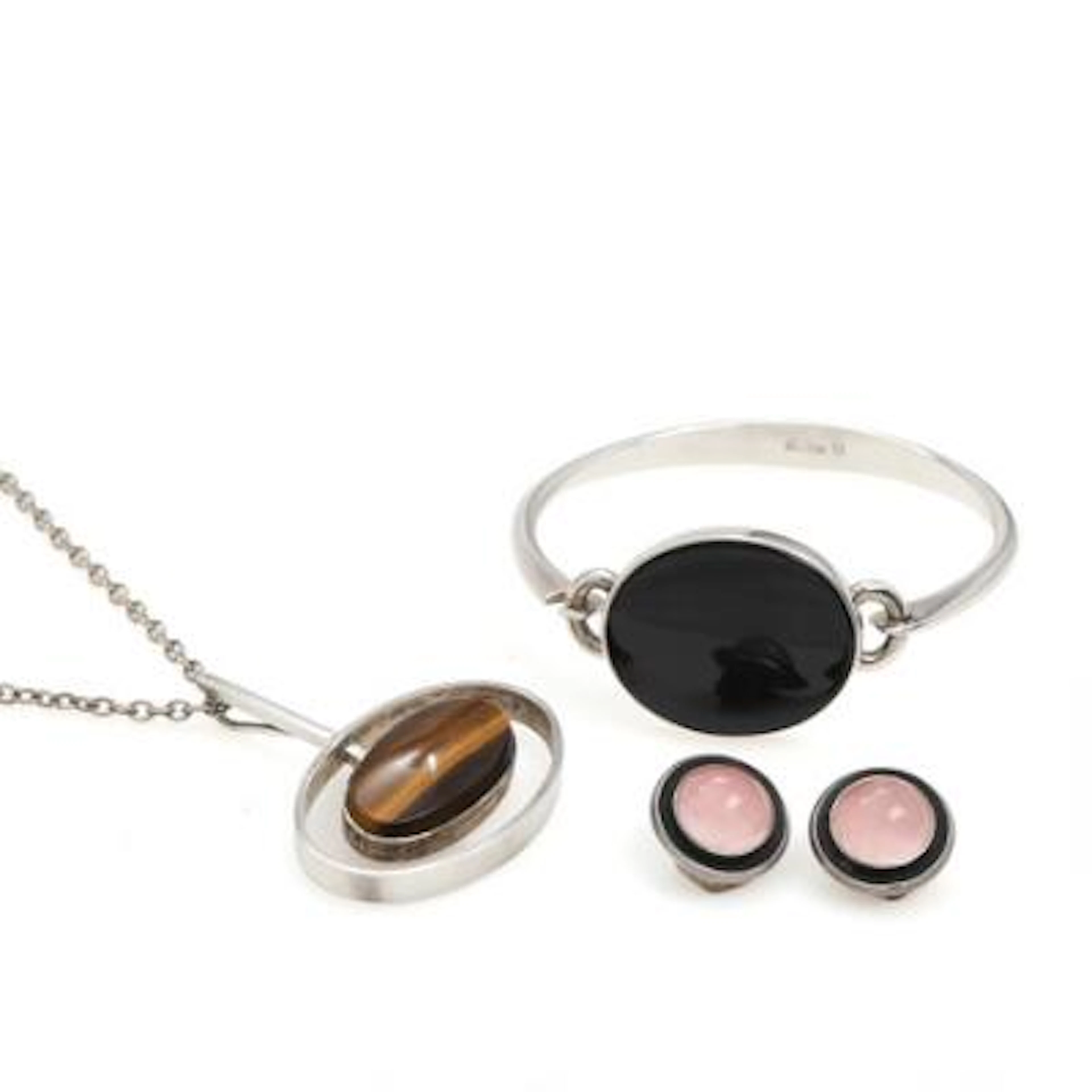 N. E. From: Pendant, bangle and pair of ear clips set with tiger's