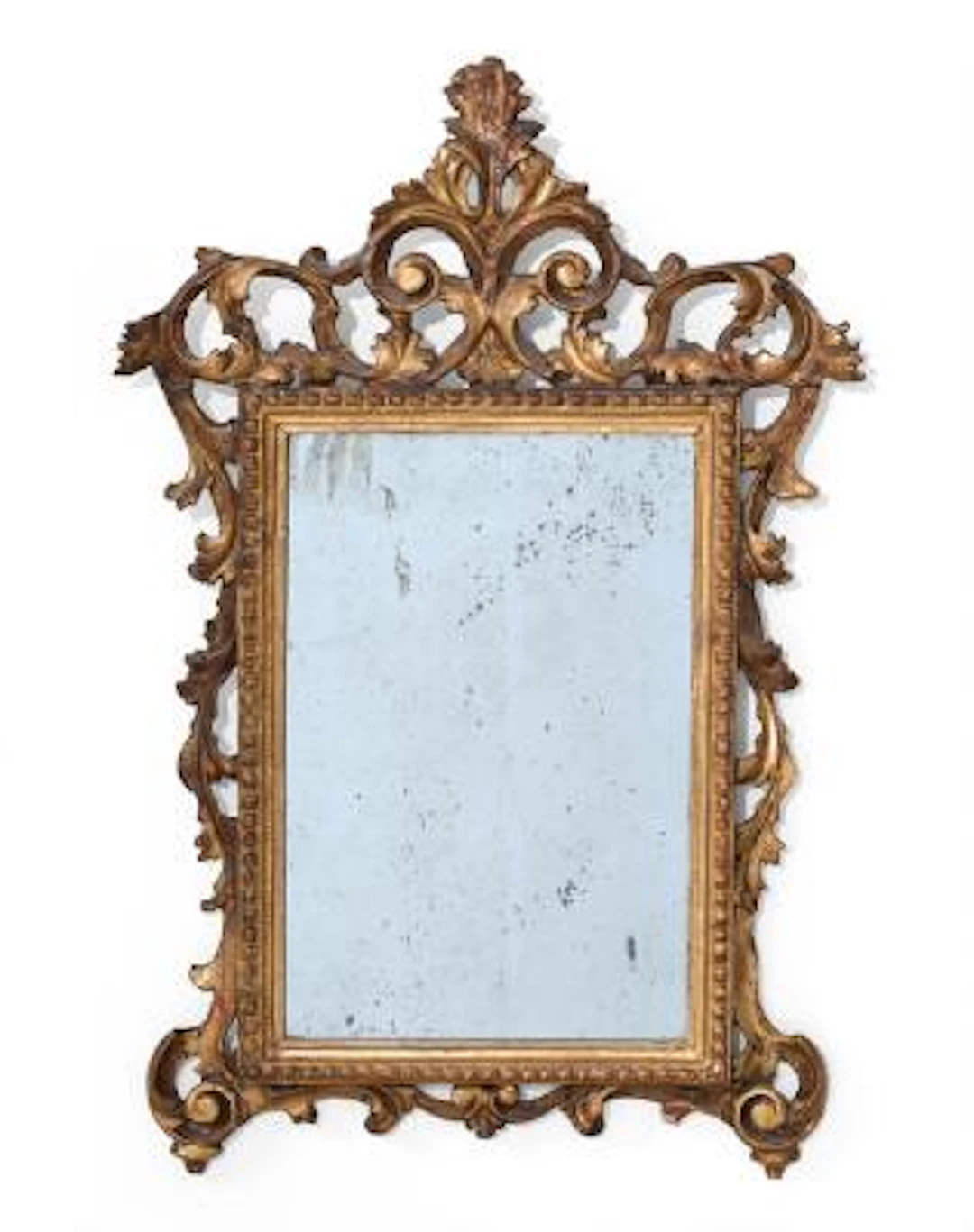 Régence mirror in frame of gilded wood, carved with openwork ornamentation.