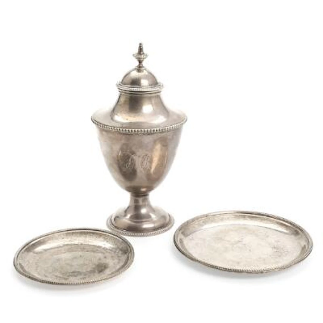 Two English bottle coasters and a teacaddy of sterling silver. London